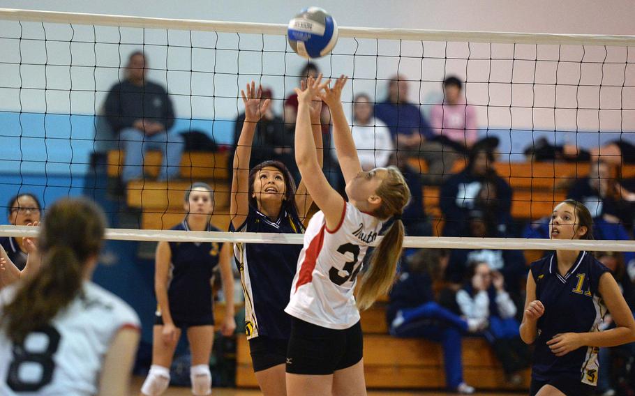 Leah Mendiola, left, and Menwith Hill's Alley LaPlante battle at the net in a Division III match at the DODSS-Europe volleyball championships, Nov. 1, 2013. Lajes defeated the Mustangs 14-25, 25-21, 15-6.