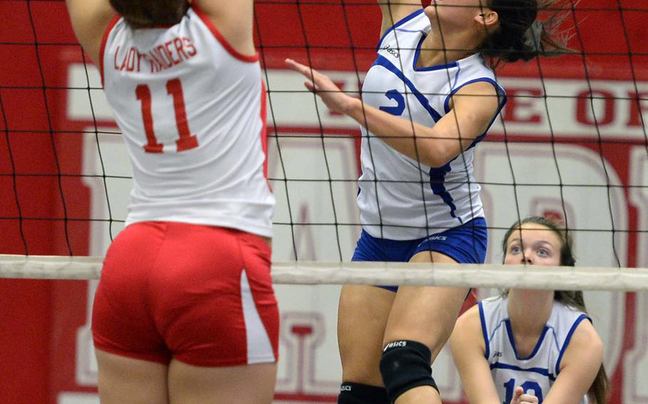 Wiesbaden's Mackinley Bullock hits the ball against Kaiserslautern's Tia Hall. Wiesbaden beat Kaiserslautern 25-20, 19-25, 25-13 in Division I action, Nov. 1, 2013.