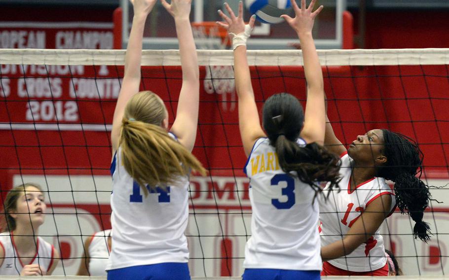 Kaiserslautern's Lashae Daniels, right, knocks the ball over the net against the defense of Wiesbaden's Brigant O' Sadnick, left, and Andriana Ibanez. Wiesbaden beat Kaiserslautern 25-20, 19-25, 25-13.