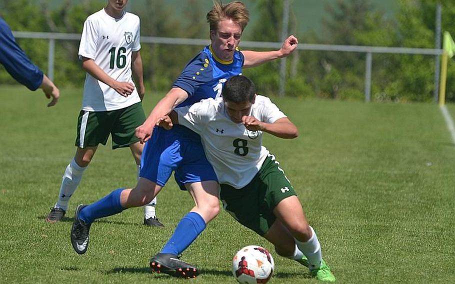 Wiesbaden's Stefan Pinkston, left, and SHAPE's Roberto Liano fight for the ball in a Division I game at the DODEA-Europe soccer championships in Reichenbach, Germany. SHAPE won 2-0.