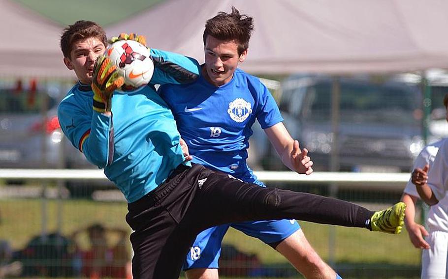 Vilseck's Timothy Simmons pulls in the ball in front of Ramstein's Connor Settle in Division I action at the DODEA-Europe soccer championships in Reichenbach, Germany. Ramstein won 3-2.