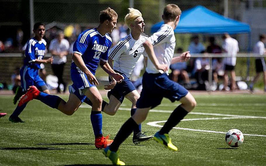 Black Forest Academy's Caleb Schmidt, center, and Jonah Olson try to beat Rota's Samuel Weaver to a pass during the DODEA-Europe soccer tournament in Landstuhl, Germany, on Wednesday, May 17, 2017. Rota and BFA finished the the Division II match 2-2.

MICHAEL B. KELLER/STARS AND STRIPES