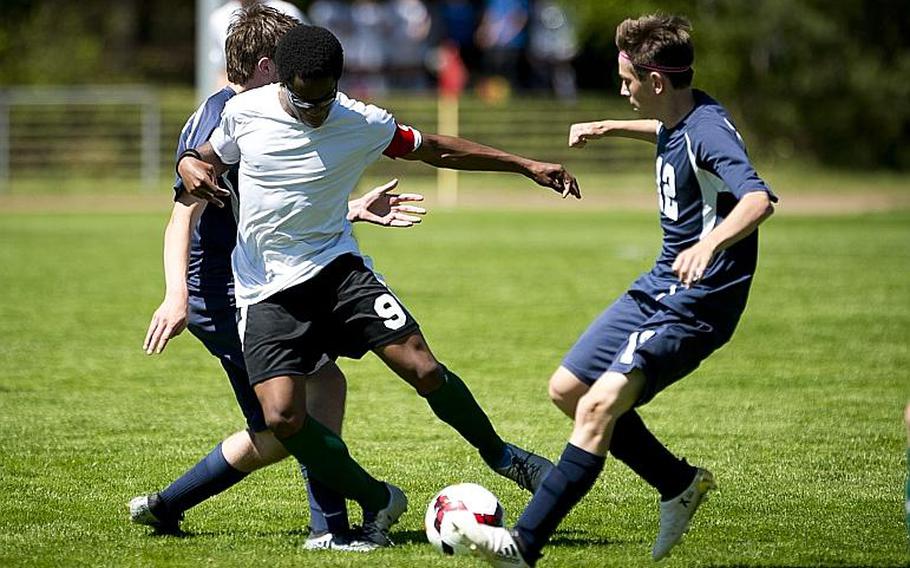 AFNORTH's Jordan Clement tries to split Bitburg's Mike Ohl, right, and Stephen Taylor during the DODEA-Europe soccer tournament in Landstuhl, Germany, on Wednesday, May 17, 2017. AFNORTH and Bitburg finished the Division II match 1-1.