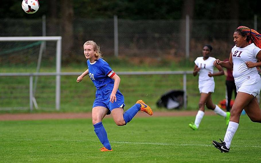 Danielle Lynch of Brussels watches her shot sail over the keeper for a goal as Baumholder's Sierra Green tries to defend. Brussels beat Baumholder 3-0 in Division III action at the DODEA-Europe soccer championships in Landstuhl, Germany.