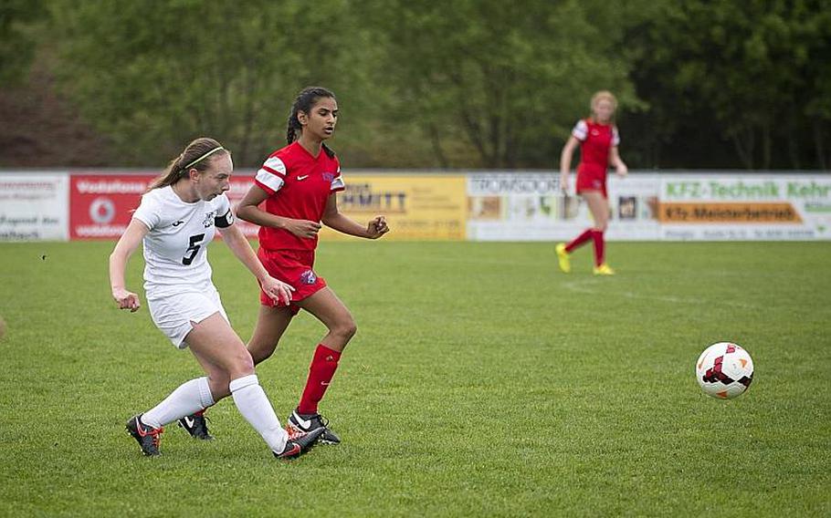 Naples' Shiloh Houseworth, left, passes the ball in front of International School of Brussels' Tasneem Amijee during the DODEA-Europe soccer tournament in Reichenbach, Germany, on Thursday, May 18, 2017. Naples won the Division I match 2-1.

MICHAEL B. KELLER/STARS AND STRIPES