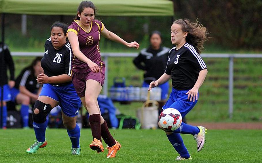 Baumholder's Taylor Lynch sends a ball upfield after getting past Hohenfles' Bryana Bentley, left, and Kayleigh Leandro n a Division III game at the DODEA-Europe soccer championships in Landstuhl, Germany.