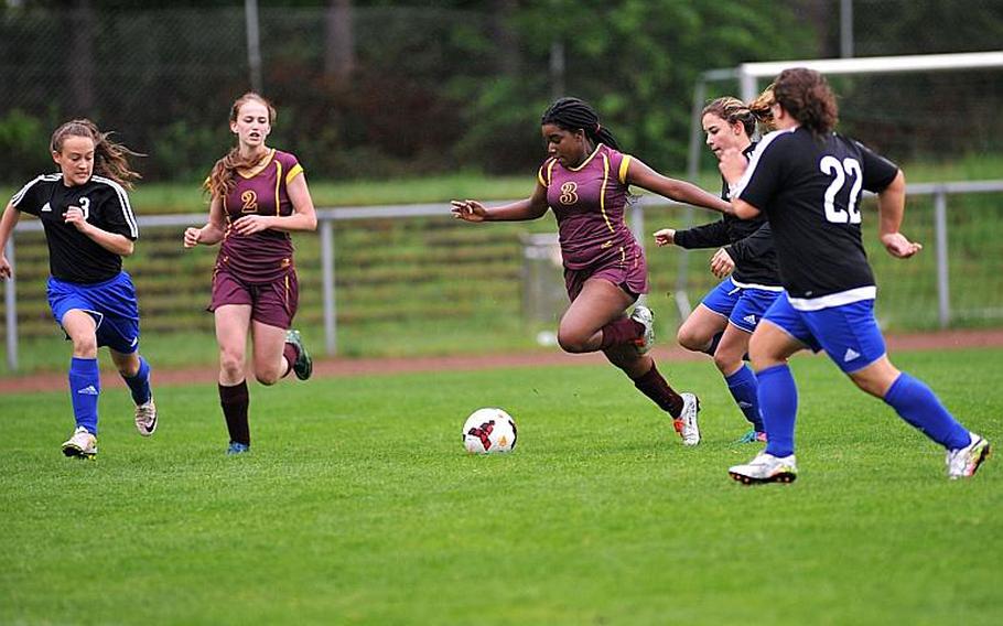 Baumholder's Laudina Gwira heads in to the box against Hohenfels' Millian Comas-Romas and Mallory Popham, as Kayleigh Leandro and Annabel Brinkmeyer follow the action at left.

Michael Abrams/Stars and Stripes
