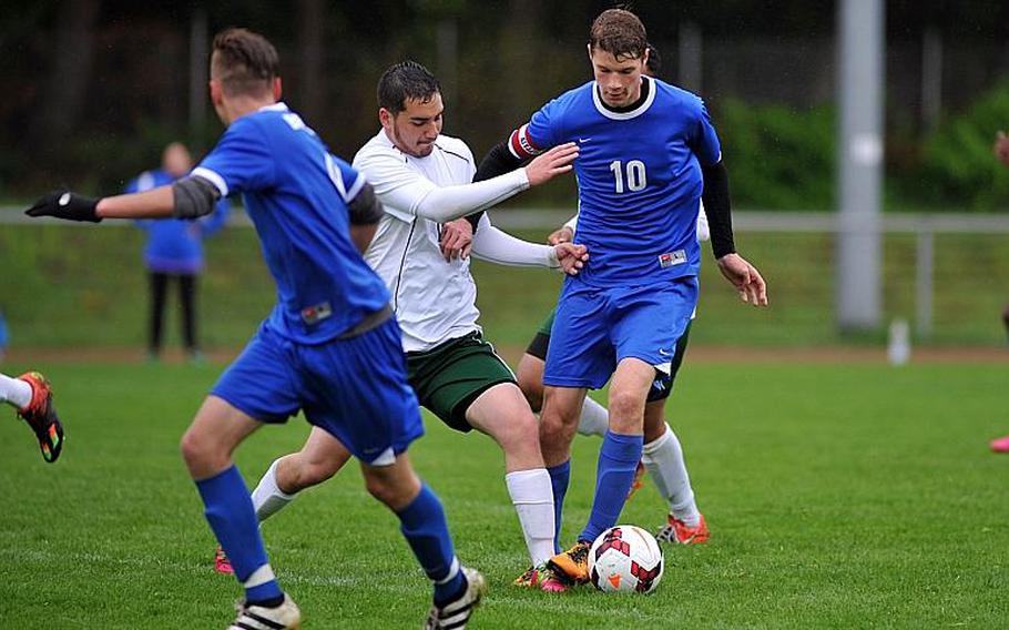 Alconbury's Devon Anderson, center, tries to stop Brussels'Alex Crowson as teammate Noah Gray starts upfield n a Division III game at the DODEA-Europe soccer championships in Landstuhl, Germany. Brussels won the game 3-1.