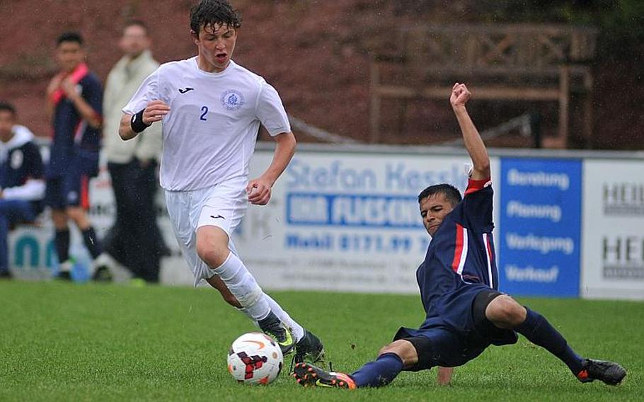 Aviano's Ruben Valladares Cruz slides in to take the ball from Marymount's Antonio Di Tommaso in a Division II semifinal at the DODEA-Europe soccer championships in Reichenbach, Germany. Marymount won 1-0 to advance to Saturday's finals.