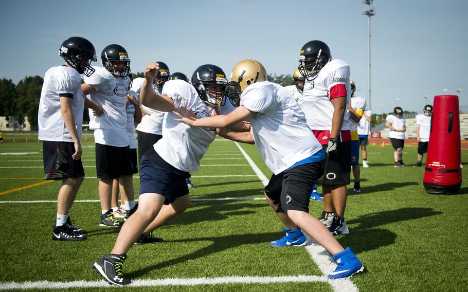 Stuttgart and Wiesbaden players run defensive drills during football camp at Vogelweh, Germany, on Tuesday, Aug. 15, 2017.