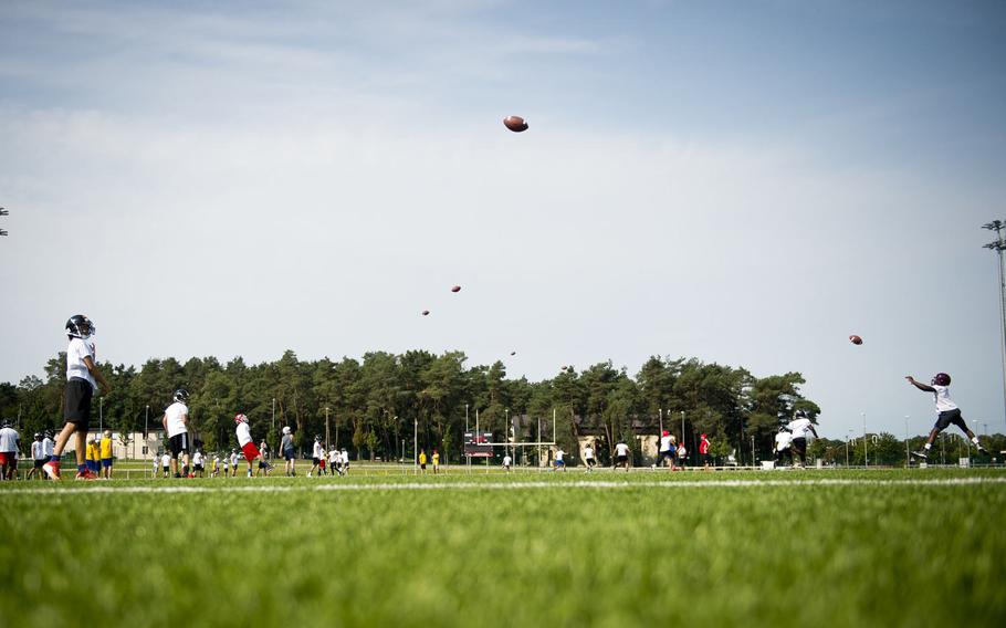 Players practice passing and catching during the annual European Football Camp at Vogelweh, Germany, on Tuesday, Aug. 15, 2017.