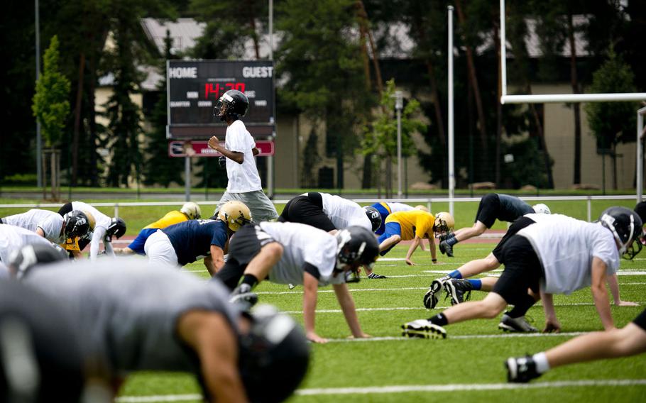 Players warm up during football camp at Vogelweh, Germany, on Tuesday, Aug. 15, 2017.