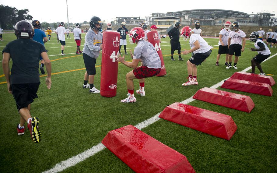 Linebackers run through a series of drills during football camp at Vogelweh, Germany, on Tuesday, Aug. 15, 2017.