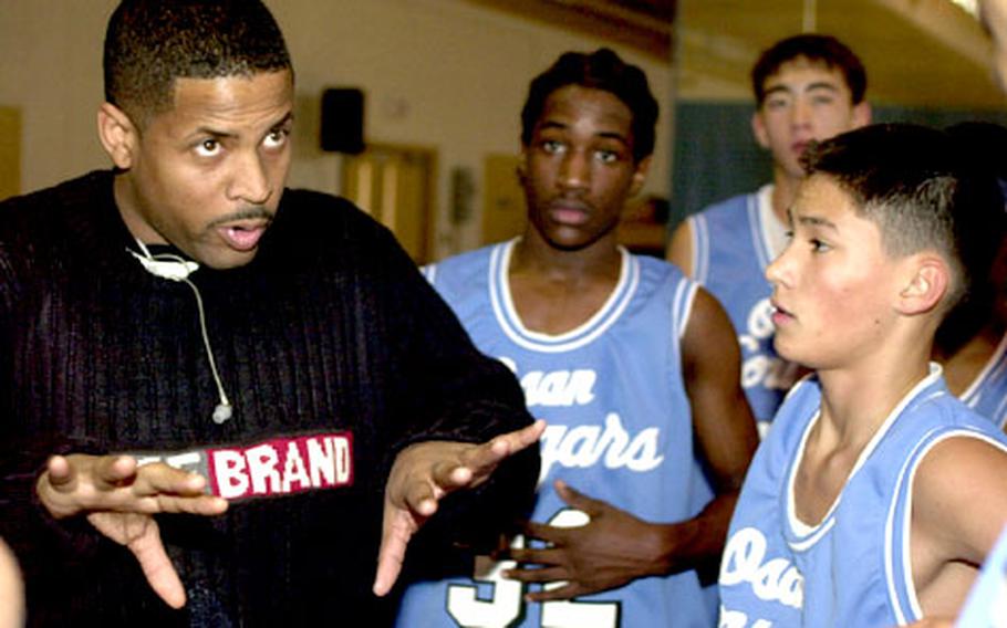 Assistant coach Dietrick Glover of the Osan American Cougars gives instructions to his charges during a timeout.