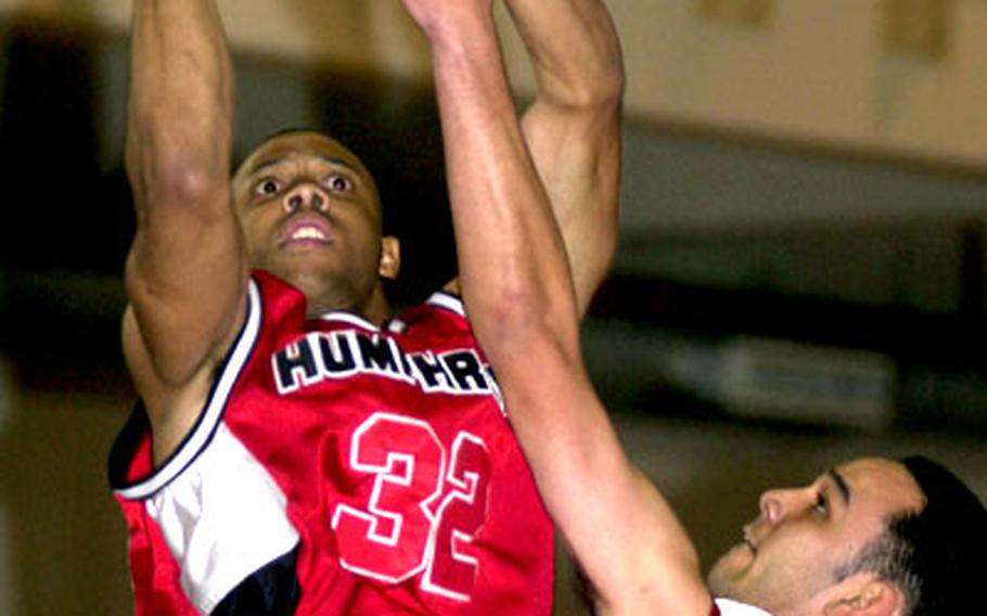 Derrick Portee of the Camp Humphreys Bulldogs shoots over Suwon Trail Blazers defender Harry LaFountaine during Wednesday&#39;s round-robin play in the Osan Pacificwide Invitational Basketball Tournament. The Bulldogs won, 106-70.