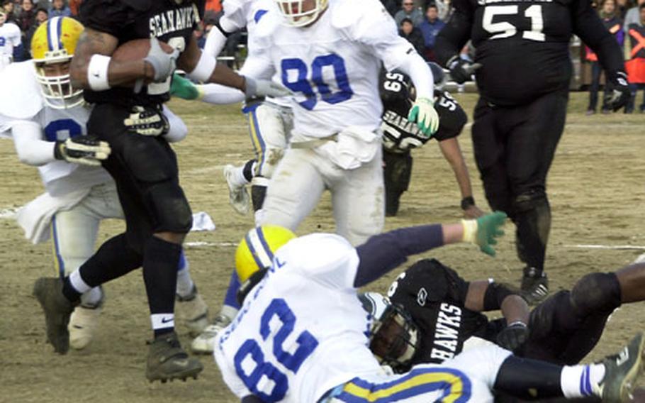 Chris Bolden (2), a runningback for the Yokosuka Seahawks, tries to avoid tripping over a downed blocker and his victim during a dash for a big gain on Saturday during the Sasebo Bowl.