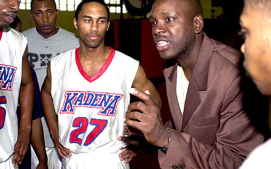 Coach Ed Gadson of the Kadena Falcons instructs his troops during a timeout in Monday&#39;s game.