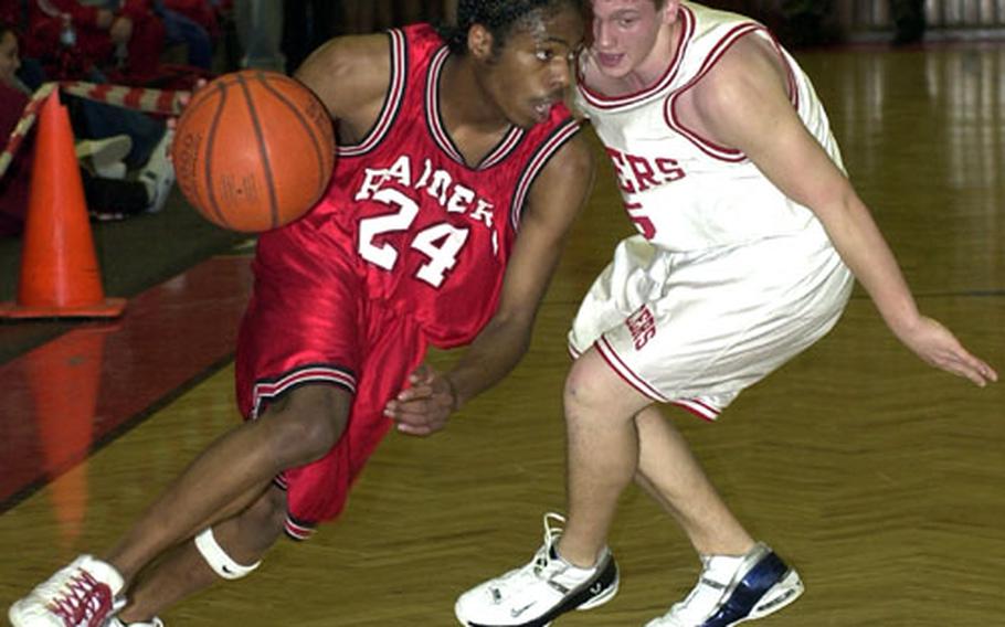 Kaiserslautern&#39;s Cliff Middleton, left, drives by Lakenheath&#39;s James Judge in DODDS Division I action in Kaiserslautern on Saturday. Kaiserslautern beat Lakenheath, 51-38.