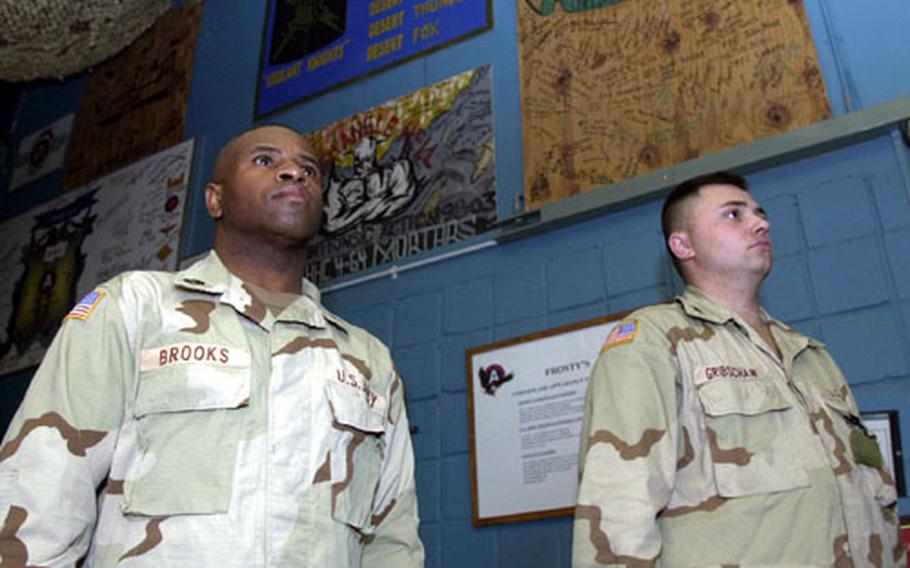 Sgt. First Class Terry Brooks (left), of Lightning Troop, 32nd Armored Cavalry Regiment, and Spc. Jason Gribschaw, of Headquarters, 11th Combat Engineers Battalion, stand at attention in Camp Doha club as the National Anthem is sung before Super Bowl XXXVII.