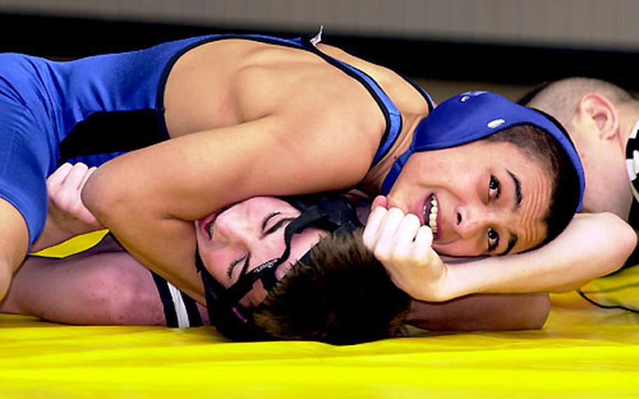 In an opening-round 103-pound match on Friday, London Central&#39;s Jonathan Scott, top, tries to pin Joseph Mueller of Bitburg. Scott won the match.