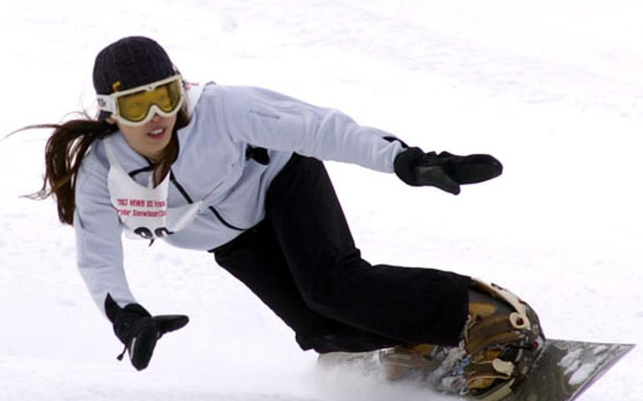 Marie Tucker of Aviano clears a gate as she rushes downhill at the 2003 U.S. Forces Europe Ski and Snowboard Series in Garmish on Saturday. Tucker was the fastest woman and one of the fastest overall with a two-heat combined time of 1 minute 50.29 seconds.