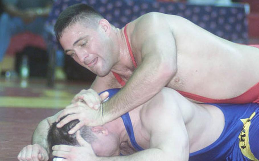 All-Marine wrestler Dan Hicks works to try to turn All-Army wrestler Franklin Lashley during a freestyle match in the 2002 Armed Forces Wrestling Championship. Hicks won two gold medals for his wrestling, one in freestyle wrestling and one in Greco-Roman wrestling.