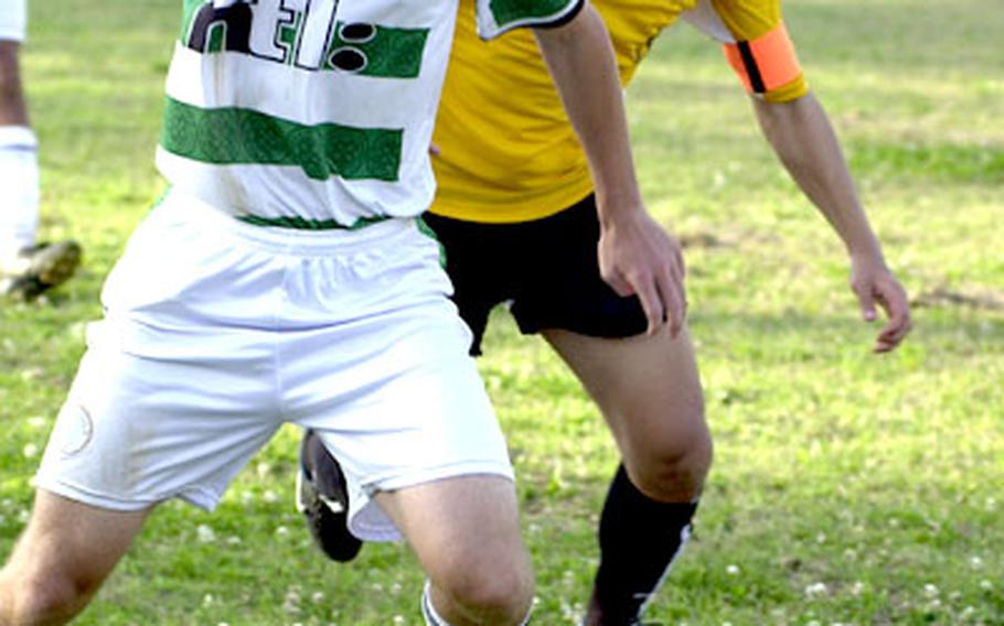 Kubasaki sophomore Daniel Ritter and Kadena senior Scott Knutson (11) battle for the ball during Thursday&#39;s match.