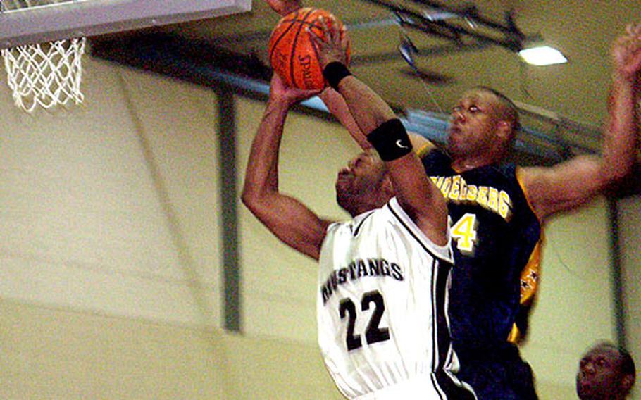 Heidelberg power forward Kenyatta Mack blocks a layup attmept by Manhheim&#39;s Will Tompkins during the championship game.