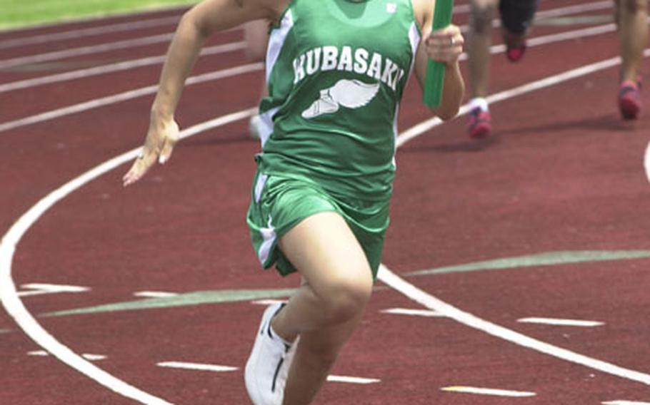 Lorianne Roxas of the Kubasaki Dragons runs the anchor leg of the girls 400-meter relay during Saturday&#39;s second-day action in the Alva W. "Mike" Petty Memorial Track and Field Meet at Mike Petty Stadium, Kubasaki High School, Camp Foster, Okinawa. Kubasaki won the event.