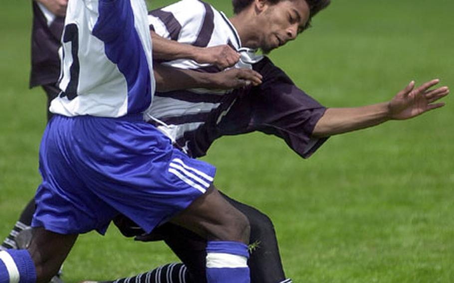 Hohenfels&#39; Fredner Reserve, left, and Baumholder&#39;s Rios Harvey fight for a loose ball during a DODDS high school soccer game in Baumholder, Germany, on Saturday.