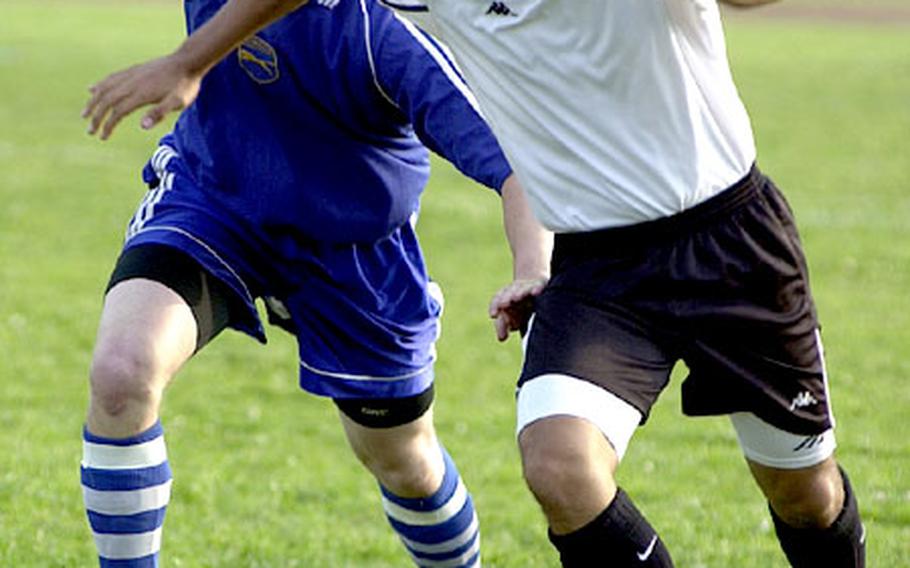 Jay Irwin of Yokota and Chris Boreham of Zama American fight for the ball.