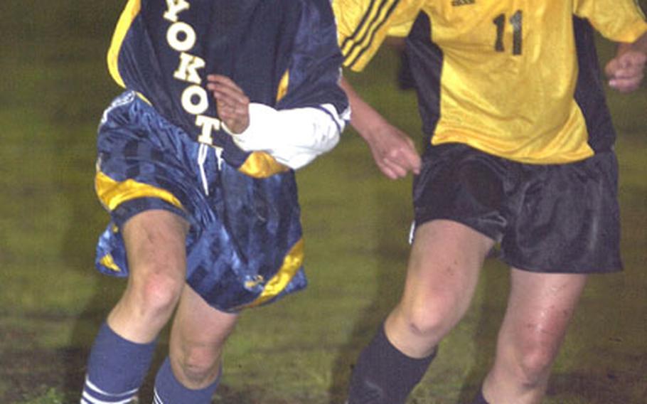 Shawna Vitarbo of the Yokota Panthers tries to take the ball past Misa Belcher of the American School In Japan Mustangs during Thursday&#39;s Kanto Plain Association of Secondary Schools match at Bonk Field, Yokota Air Base, Japan.