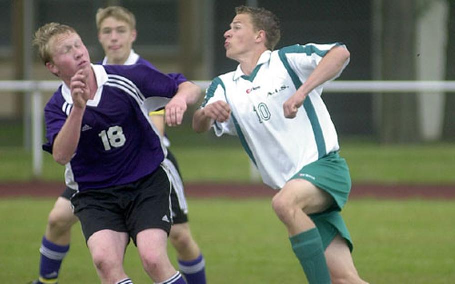 Mannheim&#39;s Charles Maskell, left, and AFNORTH&#39;s Dominick Breuer, right, race to head the ball during a DODDS soccer match in Mannheim, Germany, on Saturday.