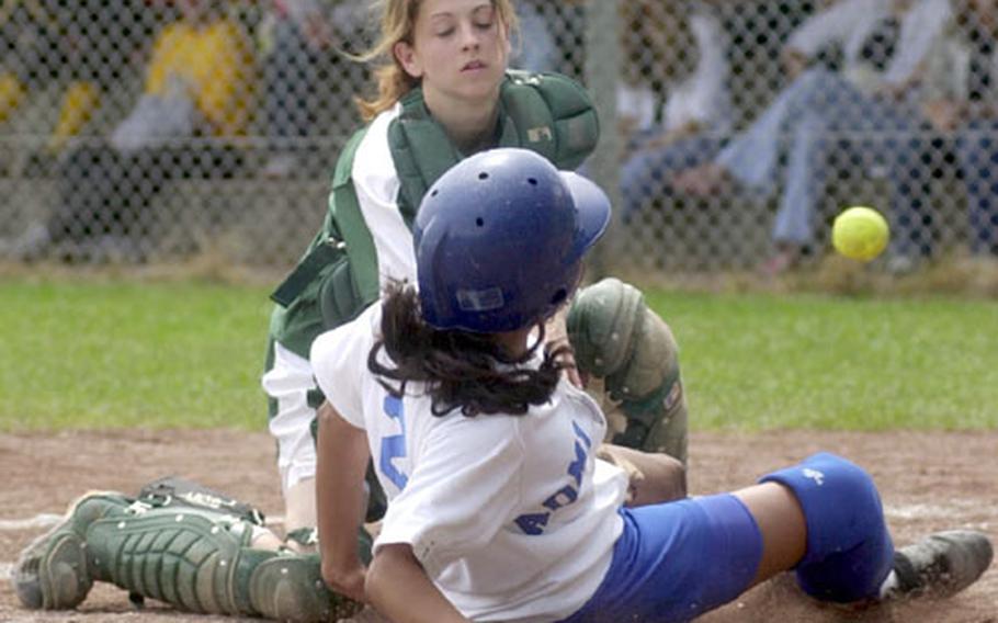 Rota&#39;s Crystal Mirales slides safely into home as Alconbury catcher Ashley Roy reaches for the ball during the DODDS Division III high school softball championships in Landstuhl, Germany, on Saturday.