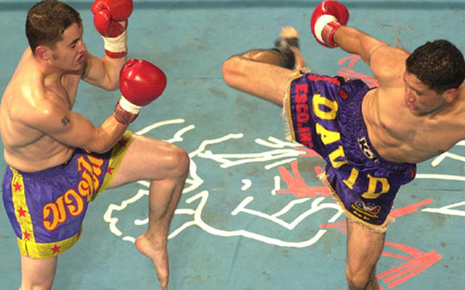 David Archuleta, right, prepares a right leg kick against Steve Satterwhite in the first round of Sunday&#39;s Universal Kickboxing Federation junior-welterweight championship bout at Differ Ariake, Tokyo.