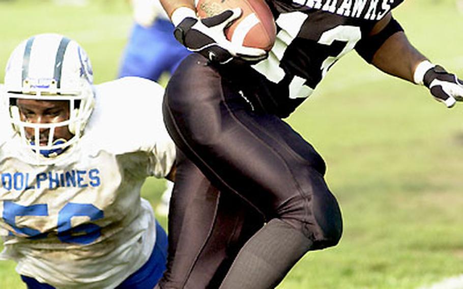 Yokosuka Seahawks defensive back Mike Favors outruns Atsugi White Dolphins lineman Byron McLendon on a 31-yard interception return.
