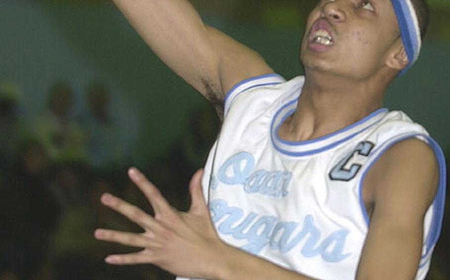 Osan American Cougars guard A.J. Scott drives to the hoops for the West team during a February 2003 game. Scott was one of nine Department of Defense Dependents Schools players earmarked for a Far East All-Star team that was supposed to play in an AAU tournament next month in Detroit, a trip that was called off.