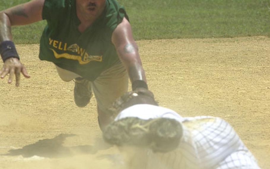 Pitcher Bill Stroup of Yellow Box tries to tag a diving Keith Serrano of Pacific Force at third base on a close play during Sunday&#39;s men&#39;s championship game of the Firecracker Shootout Open Softball Tournament at Foster Field 1, Camp Foster, Okinawa. Serrano was ruled safe on the play. Tournament Gold Glove winner Stroup and Yellow Box fell 26-12 to Pacific Force in an all-Okinawa final, Pacific Force&#39;s 37th title in the last 57 Grand Slam tournaments dating back to 1989.