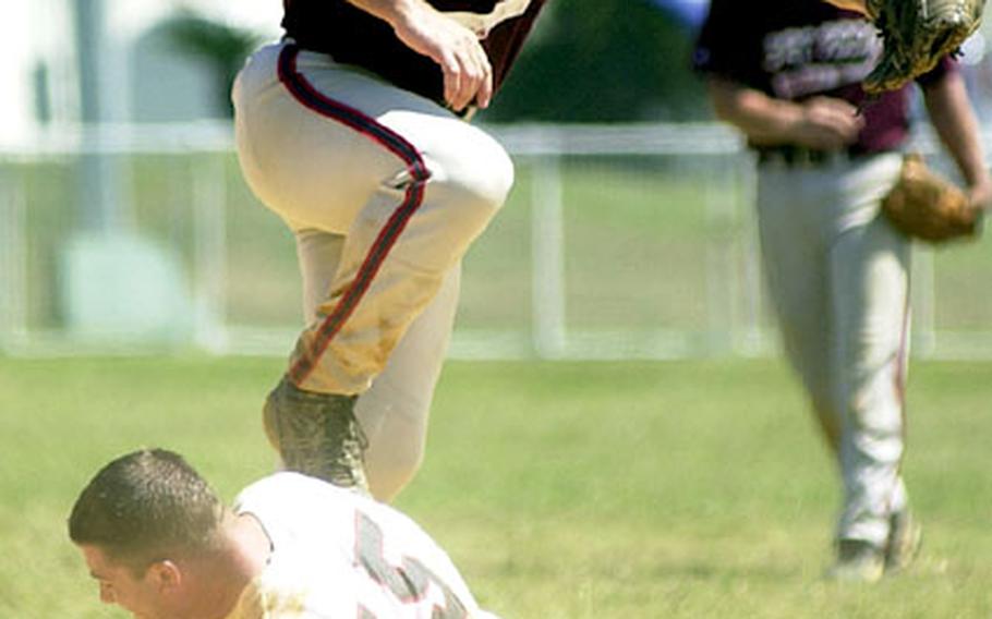 Pitcher Lee Burkett of 3rd Force Service Support Group leaps over a sliding Rory Chapin (15) of Marine Corps Base Hawaii on a force play at second base during Wednesday&#39;s round-robin play.