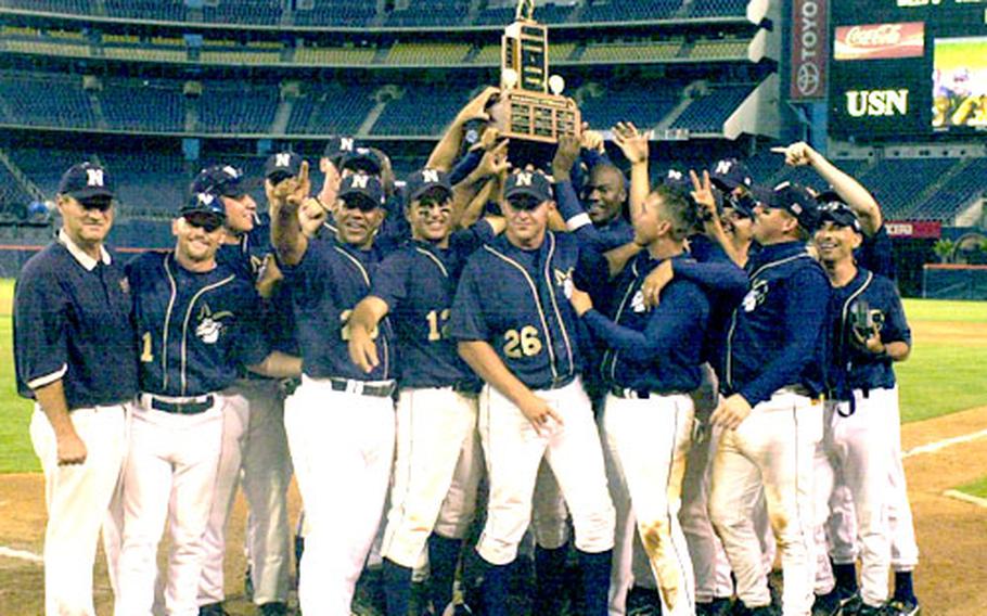 The Navy baseball team holds up the Cmdr. Lawrence S. Jackman Trophy after toppling the Marine Corps 5-3 in the Navy vs. Marine Corps Baseball Challenge at Qualcomm Stadium in San Diego.