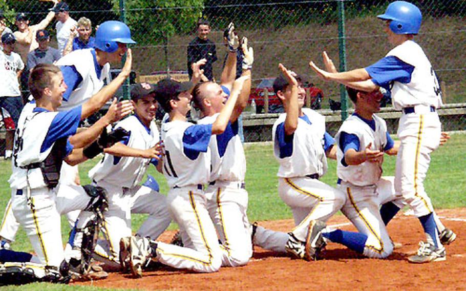 Jubilant Ukraine players go to their knees to greet unlikely hero Maxim Kiyanchenko after the light-hitting shortstop&#39;s game-winning, ninth-inning home run Friday at Little League Baseball&#39;s European Big League tournament.