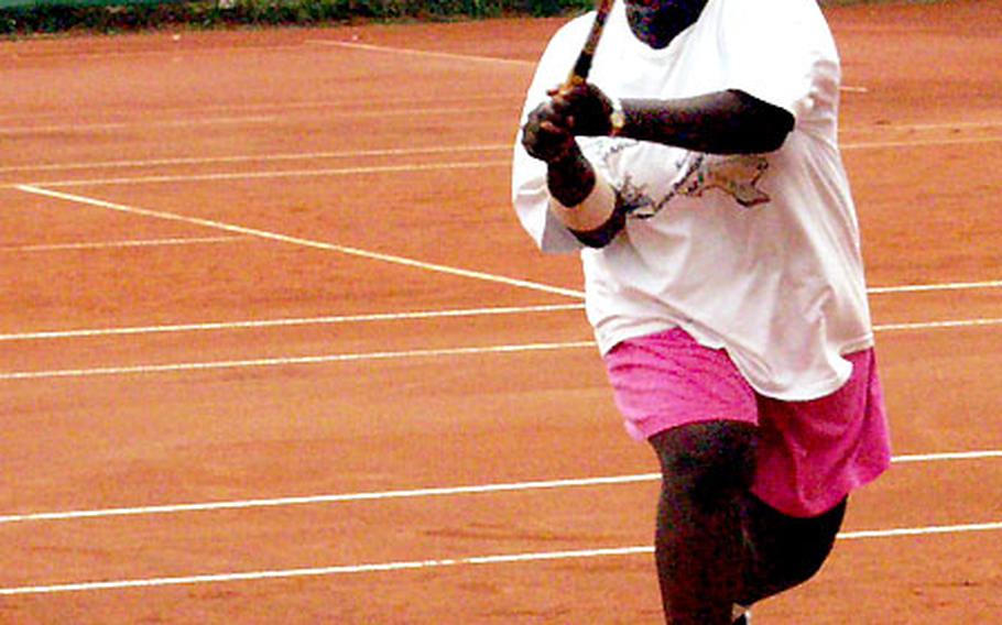 Philisa Legrier of Heidelberg volleys during the decisive set of her U.S. Forces-Europe women&#39;s doubles triumph Sunday at the Heidelberg Tennis Center.