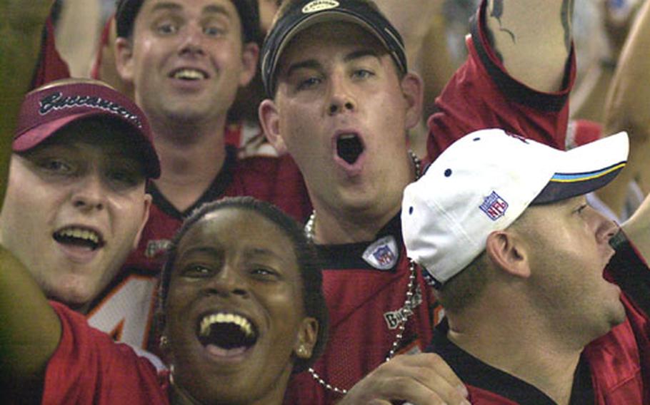 Clockwise, Tampa Bay Buccaneers fans Joshua Stargel, Scott Ekelund, Andy Tetoff, Mike Sconza and Sherry Bynoe cheer during Tim Wansley&#39;s 47-yard fumble-recovery touchdown in the fourth quarter of Saturday&#39;s NFL preseason American Bowl at Tokyo Dome. Defending Super Bowl champion Tampa Bay routed the Jets 30-14. Stargel, Tetoff and Bynoe are from Atsugi Naval Air Facility; Sconza is with security at Fleet Activities Yokosuka Naval Base; Ekelund is a civilian from Tampa who flew to Tokyo for the game.