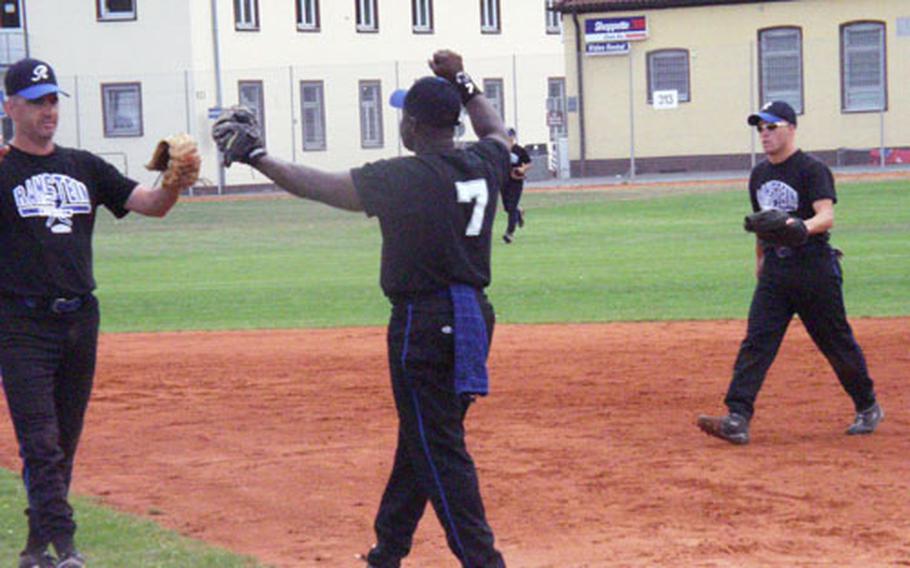 Ramstein pitcher Tim Snyder (left) and first baseman Ike Rivers touch gloves in celebration Sunday after the USAFE champion Rams added the U.S. Forces-Europe title to their resume with a 16-15 victory over Spangdahlem in Sunday&#39;s championship game of the 2003 Army-Air Force Final Four tournament. Rivers, who&#39;s ending his 13-year stint as a USAFE athlete after the game, is handing over 2004 managerial duties to Snyder.
