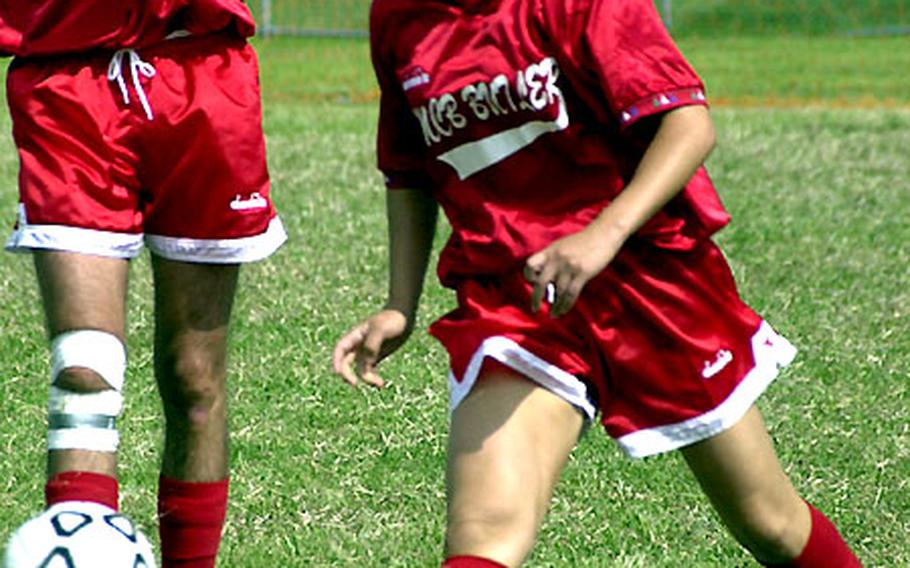 Mirna Ramos, left-forward for Marine Corps Base Camp Butler of Okinawa, boots the ball upfield during Tuesday’s game.
