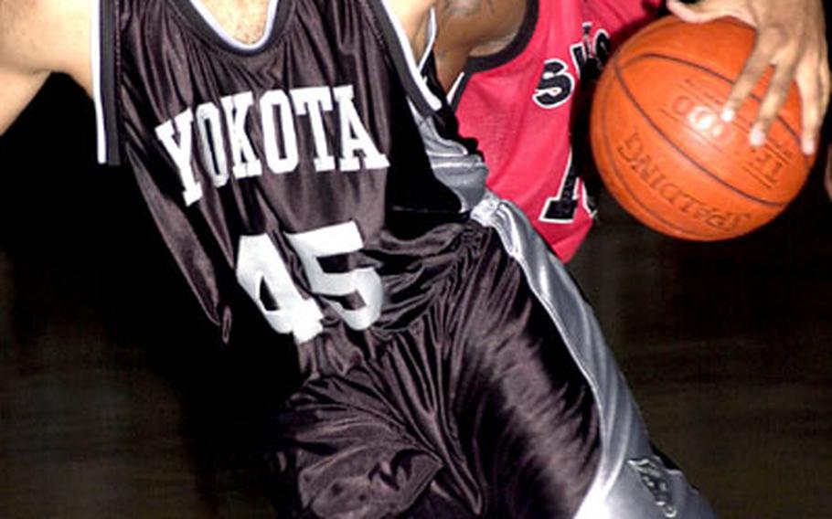 Adrian Johnson (45) of Yokota moves by MVP Willie Adams (13) of the Negishi Swish.