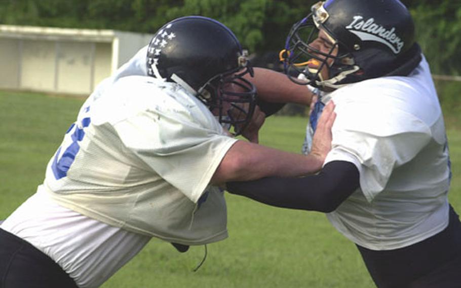 Kadena Islanders linemen Cole Maxey, left, and Jon Plascencia square off during workouts Wednesday at Kadena High School&#39;s upper field, Kadena Air Base, Okinawa. The Islanders are 4-0 and have outscored opponents 103-0 this season.