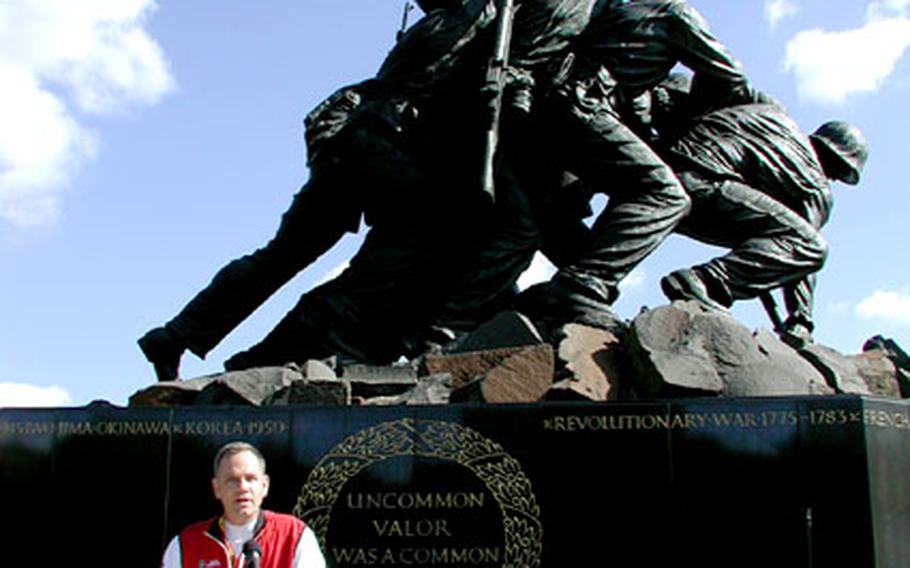 The Iwo Jima Memorial provides the backdrop as Marine Corps Marathon race director talks to the press Friday afternoon.