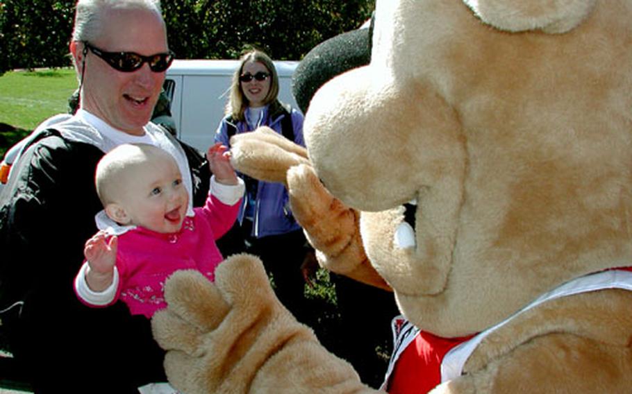 Seven-month-old Sophia Maley found a new friend in Marine Corps Marathon mascot Miles at Friday&#39;s press conference. Sophia&#39;s grandmother, Pam Penfield, will be running in her 100th marathon this weekend.