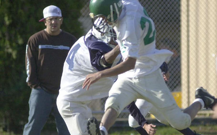 Taegu quarterback Brian McGee avoids one final tackler before leaping into the end zone for a second quarter touchdown Saturday against Seoul American at Yongsan Garrison.